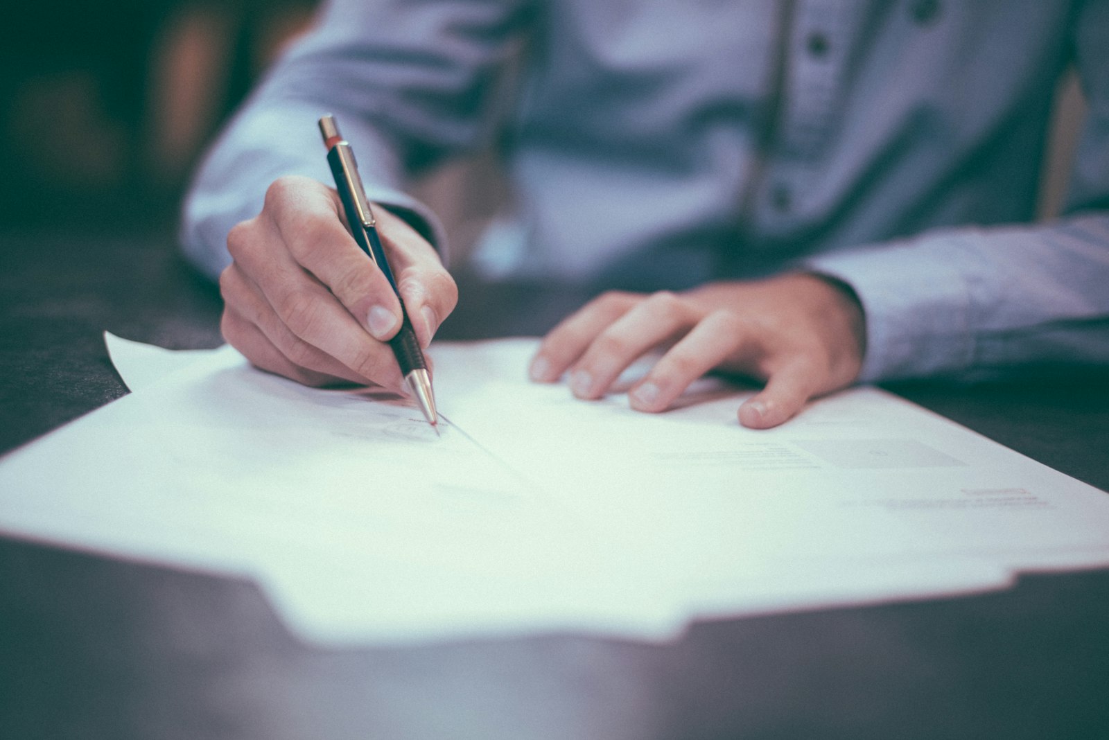 Hand signing "Sign here" document – name or surname change